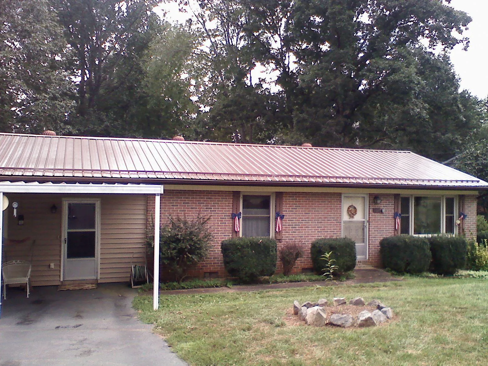 Bronze metal roof and carport on a brick ranch home — Roof Repair work by our crew in South Haven